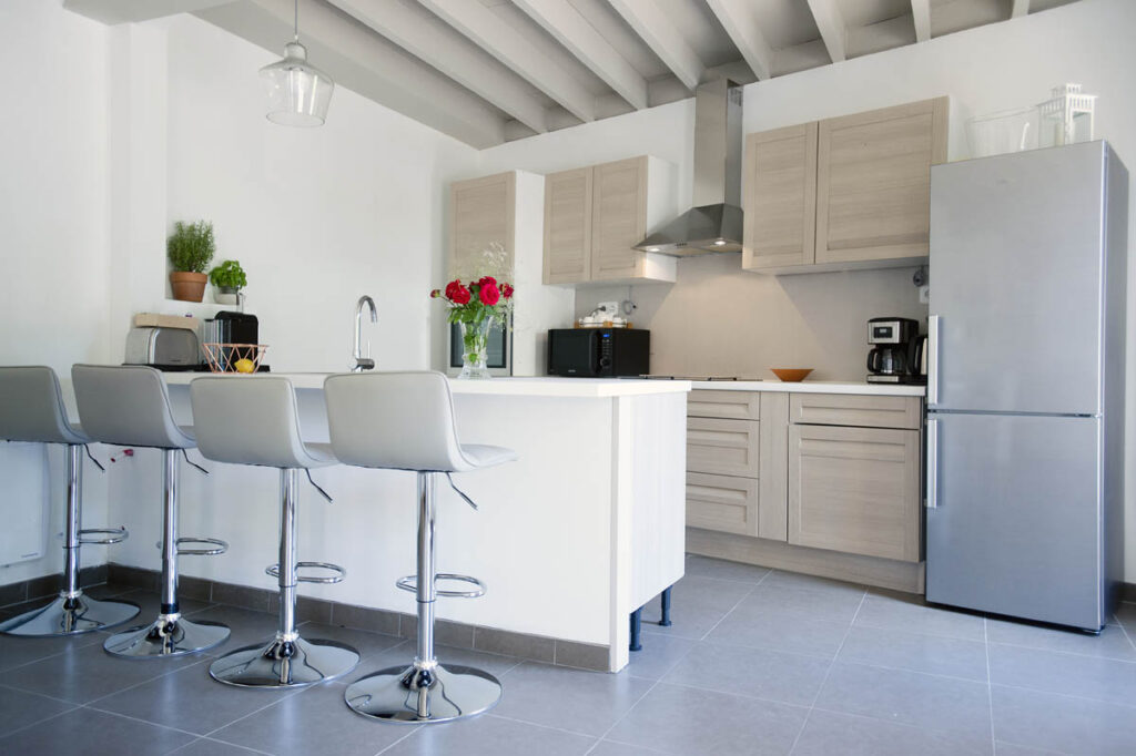 spacious kitchen with rustic beams and modern design